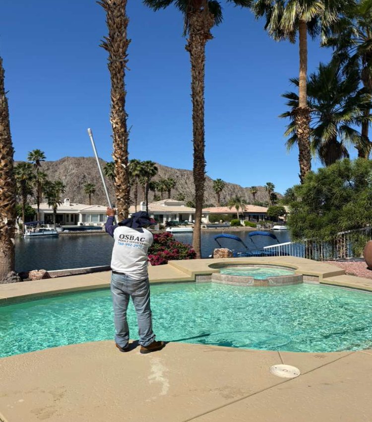 Technician cleaning pool during weekly maintenance